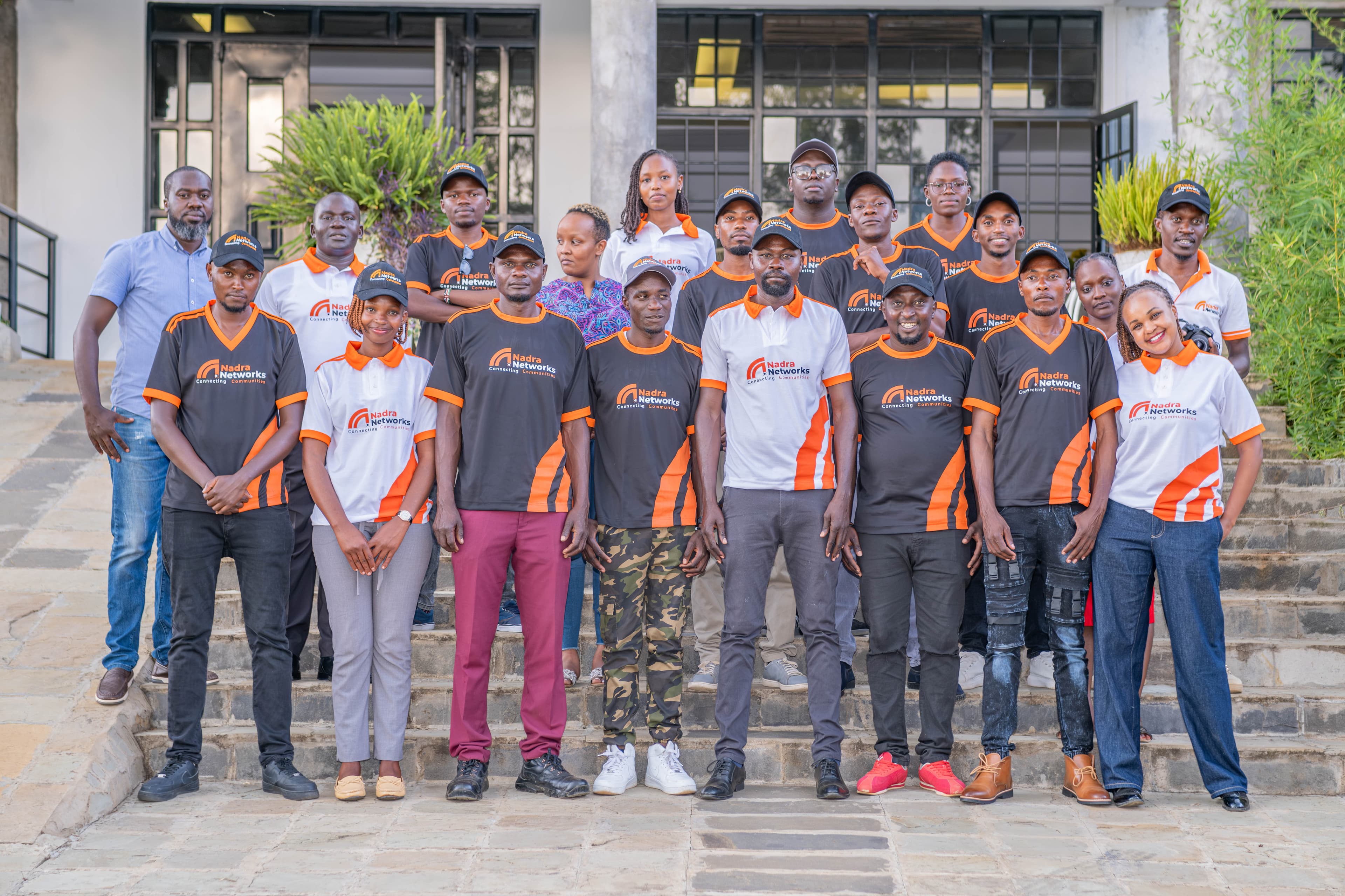Nadra Networks full team in branded orange uniforms